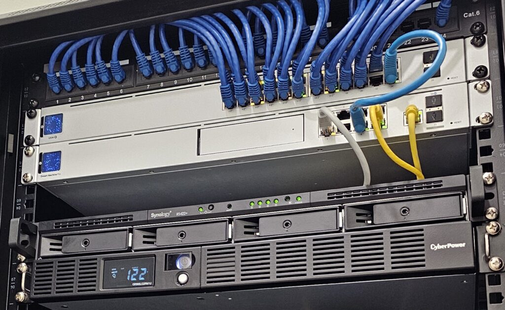 Network rack with UniFi switches and cabling installed for small business in Brevard County.